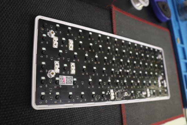 Underside of the keyboard with the new switches added but not soldered in.